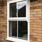 A CLOSED CENTRE BAR SASH WINDOW FRAME WITH TRIPLE GLAZED GLASS FULLY CLOSED AND LOCKED ON RESIDENTIAL HOME