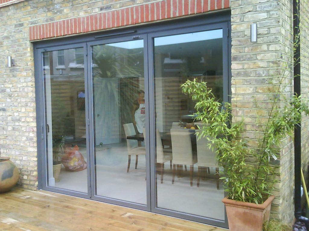 Aluminium sliding patio doors installed in a brick house